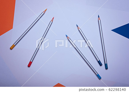Pencils lay on a white paper. 62298140