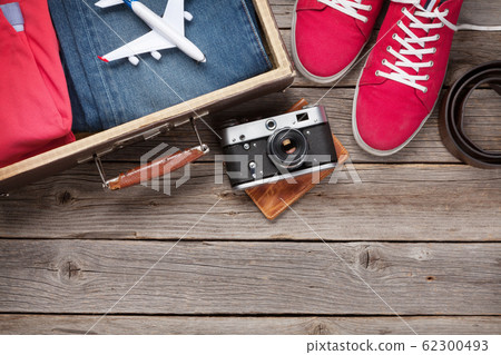 Suitcase, camera, clothes and travel accessories 62300493
