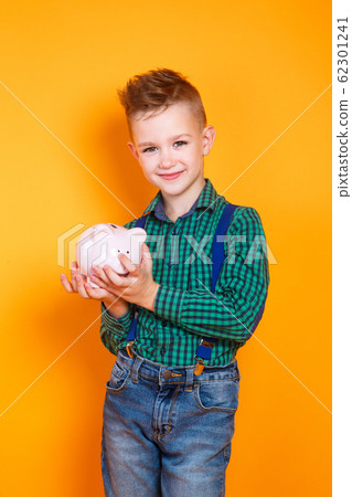 children's financial literacy. Happy kid with moneybox 62301241