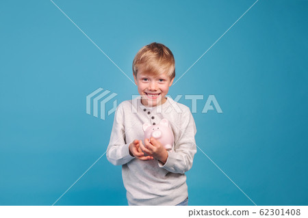 children's pocket money. Little boy with piggy Bank children's pocket money. Little boy with piggy Bank 62301408