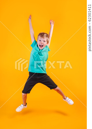 Portrait of jumping funny boy on color background Portrait of jumping funny boy on color background 62301411