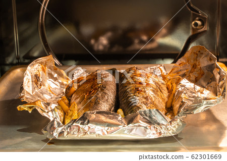 Baked mackerel fish on the pan inside gas oven Baked mackerel fish on the pan inside gas oven 62301669