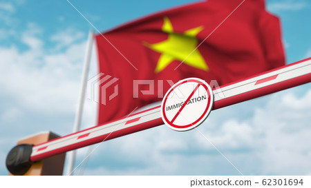 Closed boom barrier with stop immigration sign against the Vietnamese flag. Border closure or immigration ban in Vietnam. 3D rendering Closed boom barrier with stop immigration sign against the Vietnamese flag. Border closure or immigration ban in Vietnam. 3D rendering 62301694