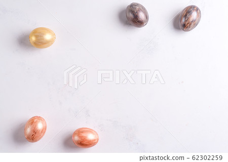 Beautiful Easter silver and gold eggs on marble background 62302259