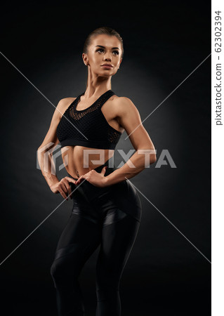 Fitnesswoman posing in sportswear. Fitnesswoman posing in sportswear. 62302394