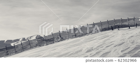Snowy ski track prepared by snowcat with trace 62302966