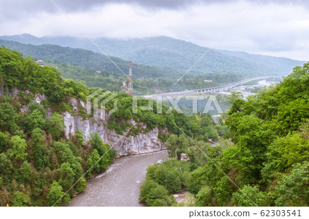 Mountain gorge with a river below. Green mountains 62303541