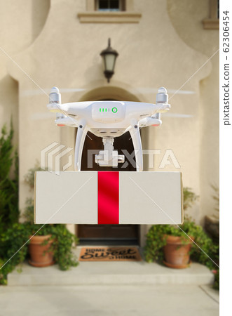 Drone Delivering Red Ribbon Wrapped Package to a Home 62306454