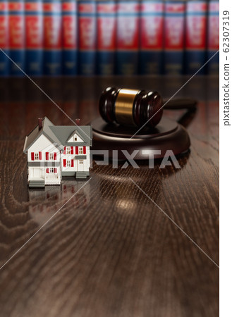 Gavel and Small Model House on Wooden Table. 62307319