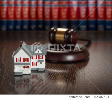 Gavel and Small Model House on Wooden Table. 62307321