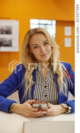 smiling business woman in blue jacket in office smiling business woman in blue jacket in office 62307384