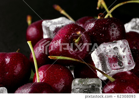Close up of pile of ripe cherries with stalks and 62308093