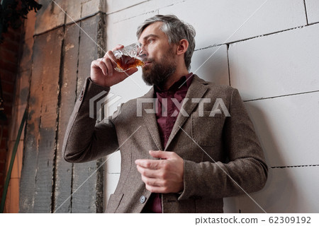 Stylish man with whisky Stylish man with whisky 62309192