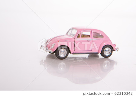 pink toy model of a real car on a white background. The concept of international women's day, happy birthday, Valentine's Day, gift Souvenirs, collectible cars. copy space 62310342