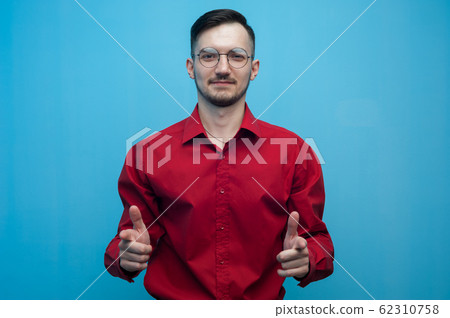 Young positive man in glasses and a red shirt 62310758