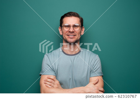 Portrait of a positive young man in glasses Portrait of a positive young man in glasses 62310767