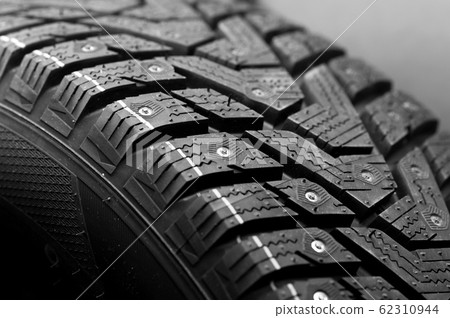 Close-up side view of a large studded tire Close-up side view of a large studded tire 62310944