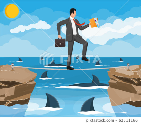 Businessman walking a tightrope over shark in sea 62311166