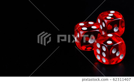 Red dice in dark black background Red dice in dark black background 62311407