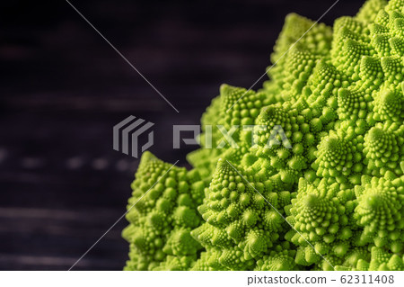 Romanesco broccoli on a dark wooden background. For vegans and a healthy diet. Copy space Romanesco broccoli on a dark wooden background. For vegans and a healthy diet. Copy space 62311408