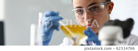 Concentrated female in white coat Concentrated female in white coat 62314766
