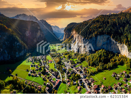 Famous Lauterbrunnen valley with gorgeous waterfall and Swiss Alps, Switzerland. Famous Lauterbrunnen valley with gorgeous waterfall and Swiss Alps, Switzerland. 62315384