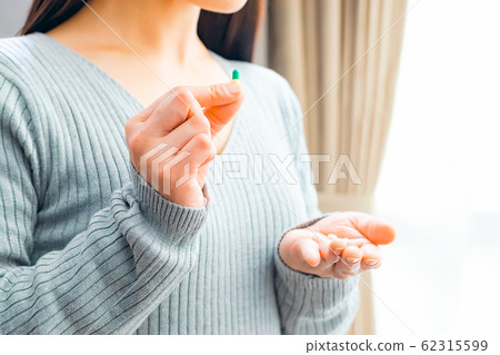 Woman taking medicine 62315599