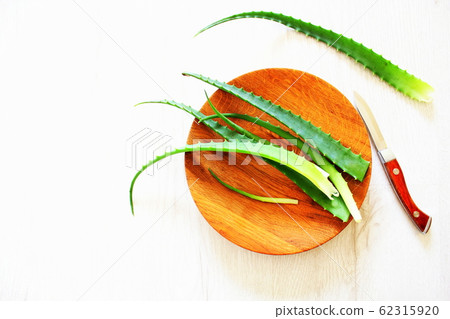 Leaf of fresh aloe vera on wooden plate , natural clear gel 62315920