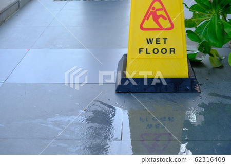 Yellow sign showing warning of caution wet floor Yellow sign showing warning of caution wet floor 62316409