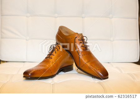 Still life of a pair of classical light brown men shoes. Still life of a pair of classical light brown men shoes. 62316517