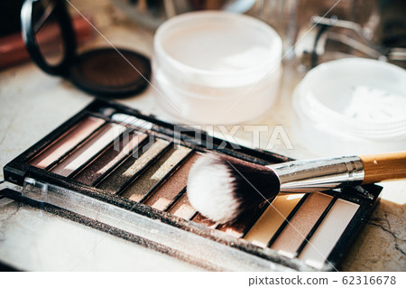 Eyeshadow palette in beige colors with makeup brush Eyeshadow palette in beige colors with makeup brush 62316678