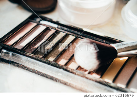 Eyeshadow palette in beige colors with makeup brush Eyeshadow palette in beige colors with makeup brush 62316679