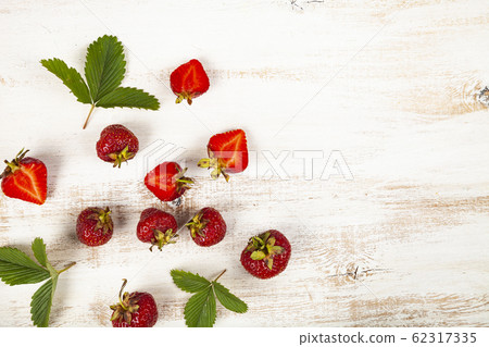 Ripe strawberries on a wooden table. Ripe strawberries on a wooden table. 62317335