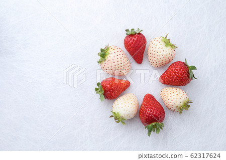 Ring made of red and white strawberries placed on Japanese paper Ring made of red and white strawberries placed on Japanese paper 62317624
