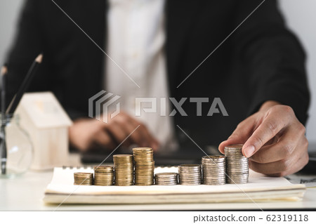 Silver and gold coins stacked on the work 62319118