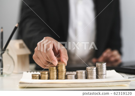 Silver and gold coins stacked on the work 62319120