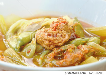 boiled mixed vegetable and fish egg in Thai spicy soup on bowl 62320203