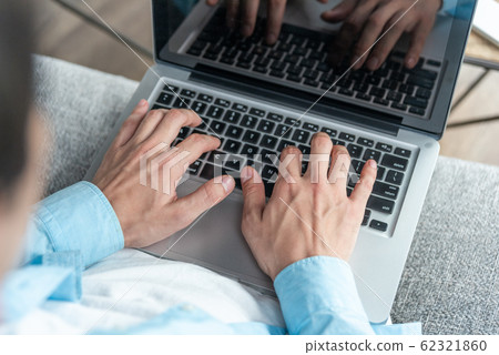 擊中膝上型計算機的男性手 擊中膝上型計算機的男性手 62321860