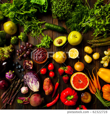 Fruits and vegetablew on dark wooden surface Fruits and vegetablew on dark wooden surface 62322728