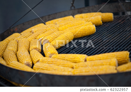 Grilled corn. Street food festival. Close up of appetizing grilled sweet corn on the bbq grill. 62322957