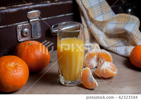 Unpeeled round ripe orange mandarins or 62323584