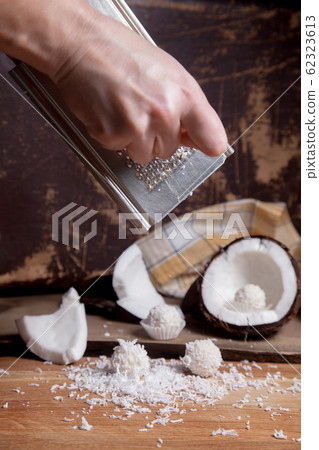 Close up of coconut with white pulp, grater with Close up of coconut with white pulp, grater with 62323613