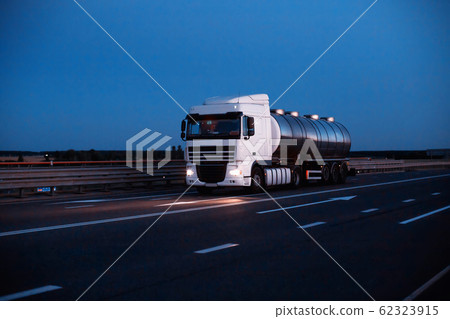 A truck driver is transporting dangerous goods in a tank. The concept of transportation of dangerous goods ADR truckers, copy space 62323915