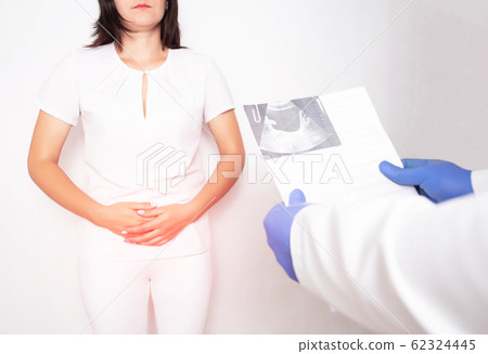 The doctor urologist holds the results of the examination of the ultrasound diagnostics of the bladder in a girl, the concept of bladder cancer 62324445