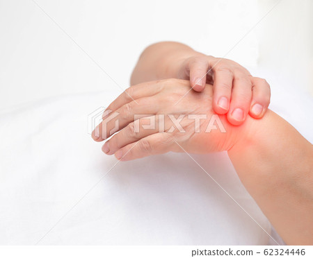 Woman holds on wrist joint on a white background. The concept of pain and inflammation of the wrist joint, tunnel syndrome and arthritis, copy space 62324446