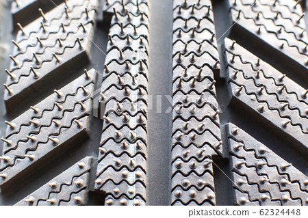 The tread of the new winter tires, macro, background The tread of the new winter tires, macro, background 62324448