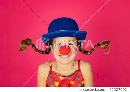 Funny girl clown playing indoor 62327002