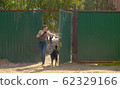Woman volunteer walking with a dog 62329166