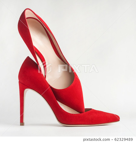 Red shoes on white background. Women's stilettos close up. 62329489