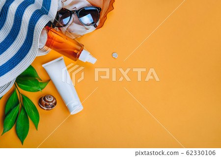 Sanscreen. Beach set: hat, sun glasses and protection cream SPF Beach accessories. Summer Travel Vacation Concept Sanscreen. Beach set: hat, sun glasses and protection cream SPF Beach accessories. Summer Travel Vacation Concept 62330106
